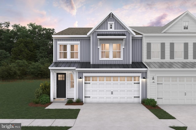 view of front of home featuring a garage and a lawn