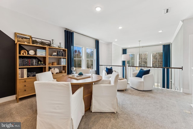 carpeted dining area featuring ornamental molding