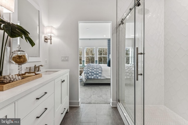 bathroom featuring tile patterned floors, a shower with door, and vanity