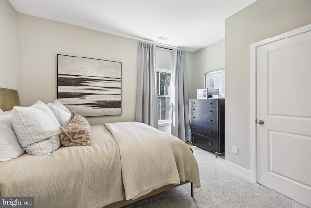 bedroom with light colored carpet