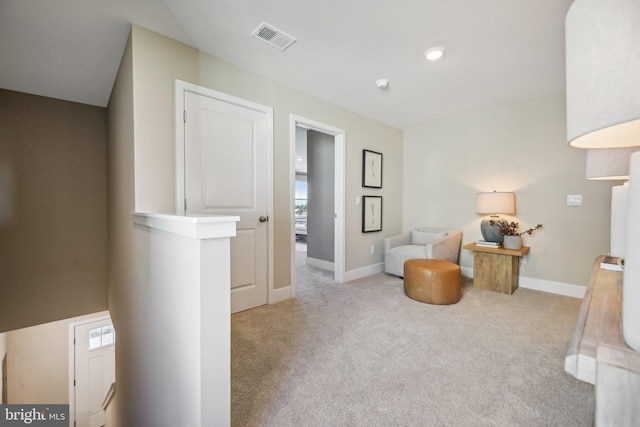 sitting room featuring light colored carpet