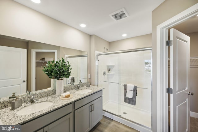 bathroom with vanity, hardwood / wood-style flooring, and an enclosed shower