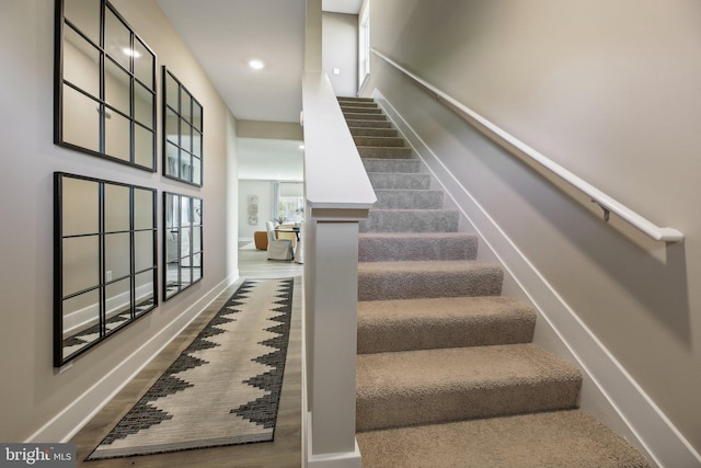 stairs featuring hardwood / wood-style floors