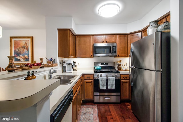 kitchen with sink, dark wood-type flooring, and appliances with stainless steel finishes