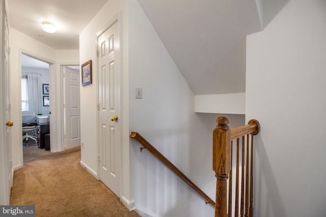 hall with light colored carpet