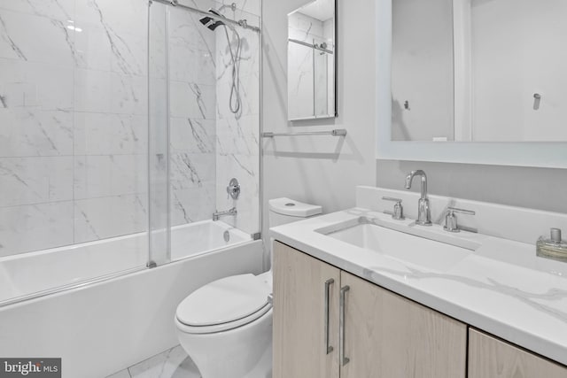 full bathroom with vanity, tiled shower / bath combo, and toilet