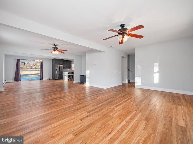 unfurnished living room featuring hardwood / wood-style floors and ceiling fan