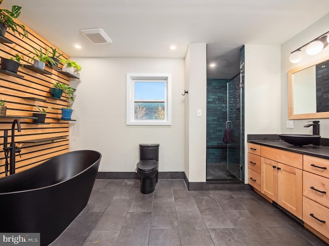 bathroom with vanity and independent shower and bath