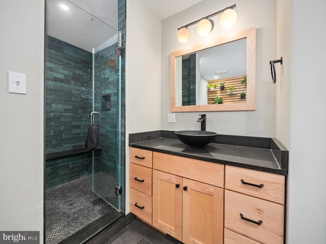 bathroom featuring vanity and a shower with door