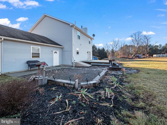 back of property with a lawn