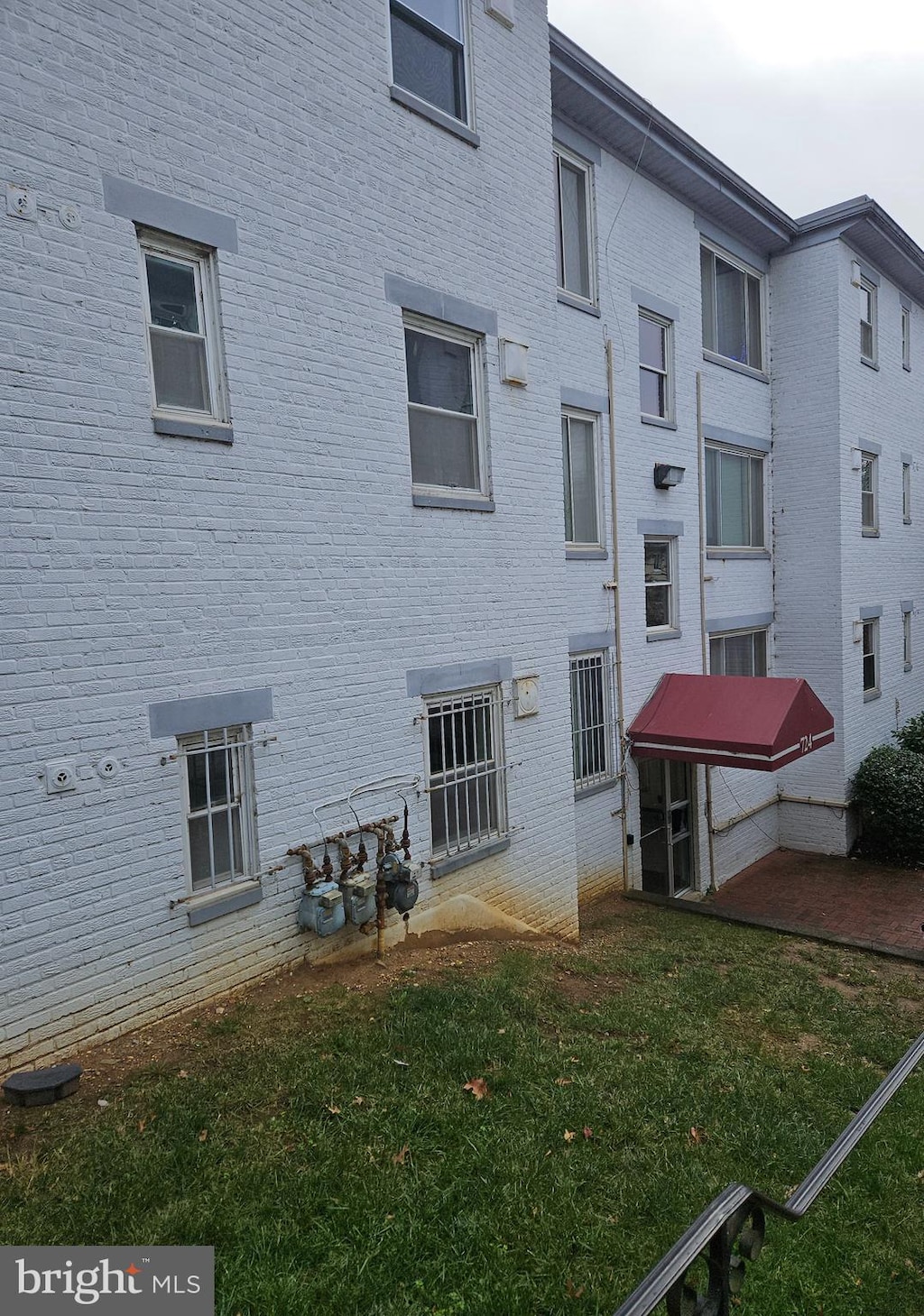724 Brandywine St SE Unit 204, Washington, DC 20032 - rear view of house featuring brick siding and a lawn