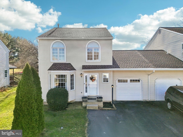 view of front of house featuring a front yard and a garage