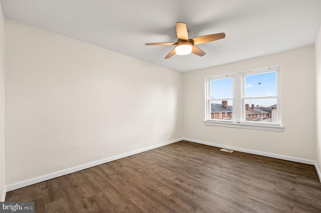 spare room featuring dark hardwood / wood-style floors and ceiling fan