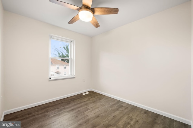 unfurnished room with ceiling fan and dark wood-type flooring