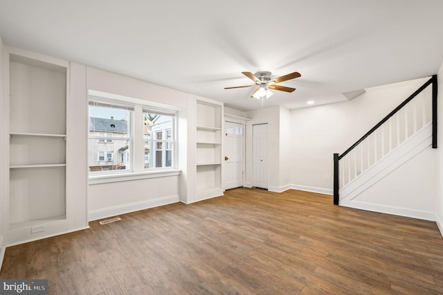 unfurnished living room featuring hardwood / wood-style flooring and ceiling fan