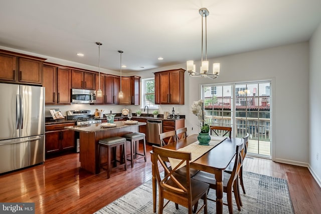 dining room with dark hardwood / wood-style flooring, sink, and a chandelier