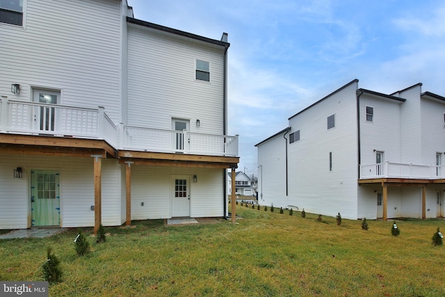 rear view of house featuring a yard