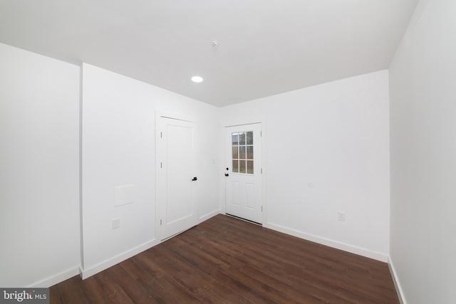 empty room with dark wood-type flooring