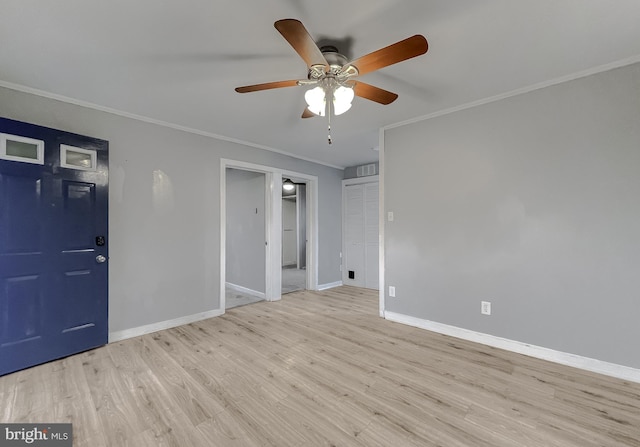 unfurnished room with ceiling fan, light wood-type flooring, and ornamental molding