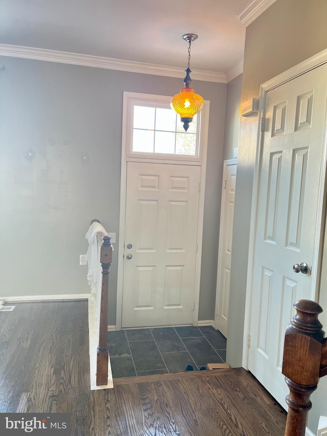 foyer featuring dark hardwood / wood-style flooring and ornamental molding