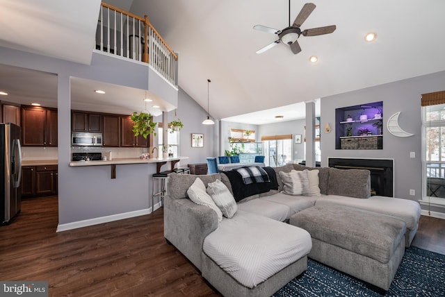 living room with ceiling fan, sink, high vaulted ceiling, and dark hardwood / wood-style floors