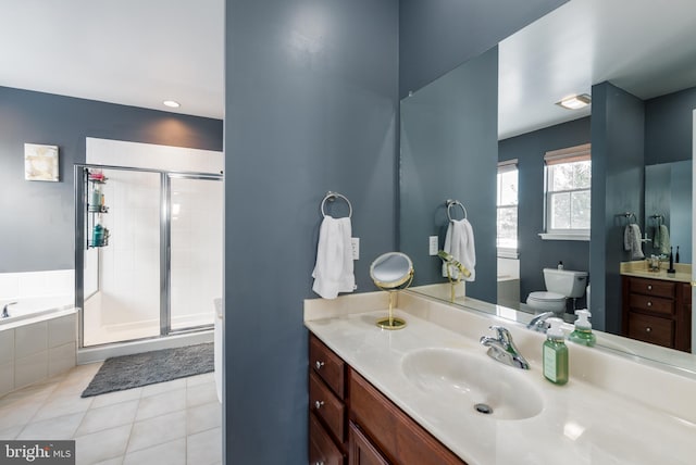 full bathroom featuring tile patterned floors, vanity, toilet, and shower with separate bathtub