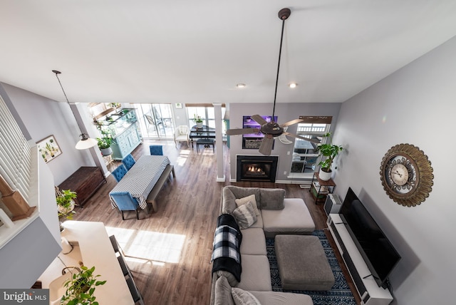 living room with floor to ceiling windows, hardwood / wood-style floors, and ceiling fan