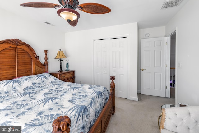 carpeted bedroom featuring ceiling fan and a closet