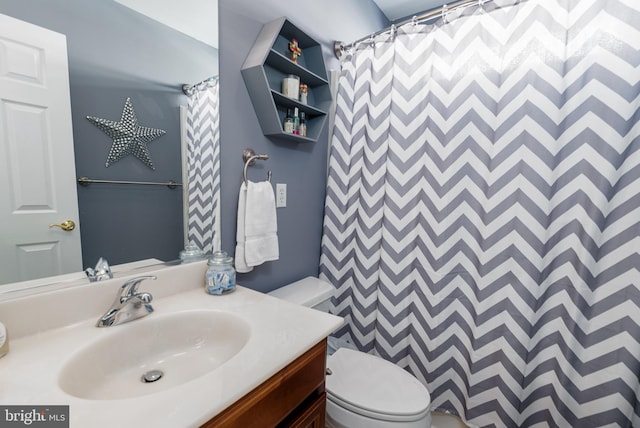 bathroom with a shower with shower curtain, vanity, and toilet