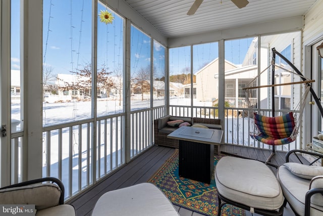 sunroom with a wealth of natural light and ceiling fan