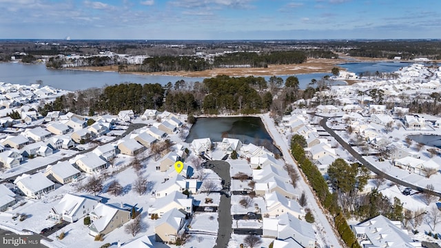 snowy aerial view featuring a water view