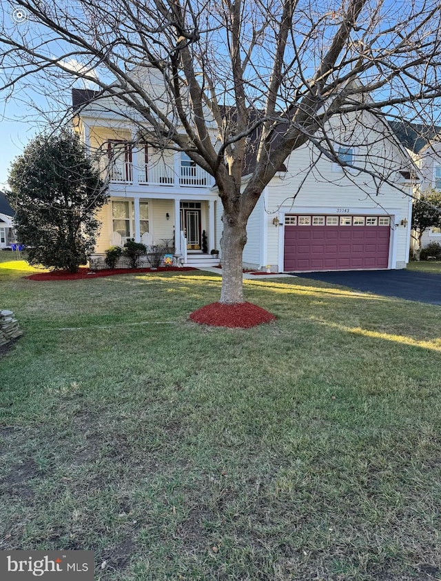 view of front of property featuring a balcony and a front lawn