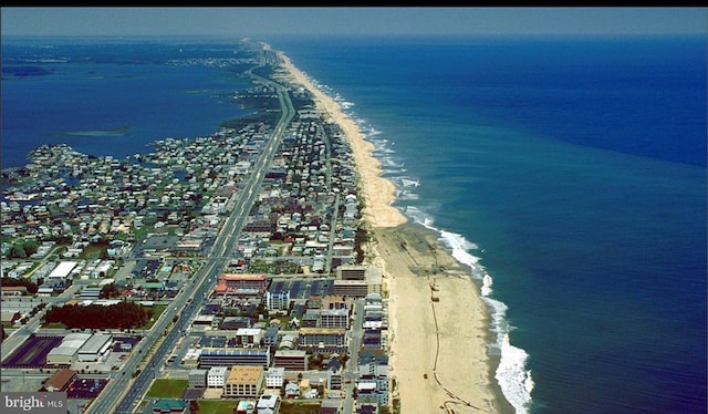 drone / aerial view featuring a water view and a beach view