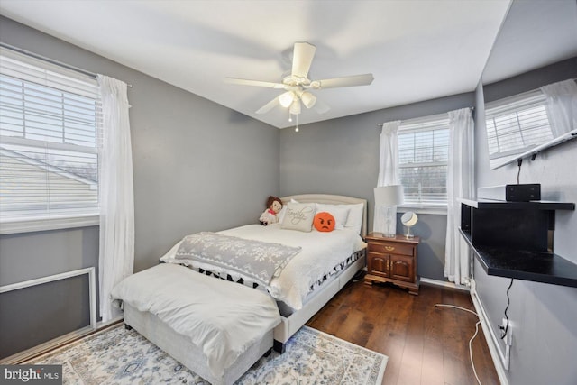 bedroom with ceiling fan and dark hardwood / wood-style flooring