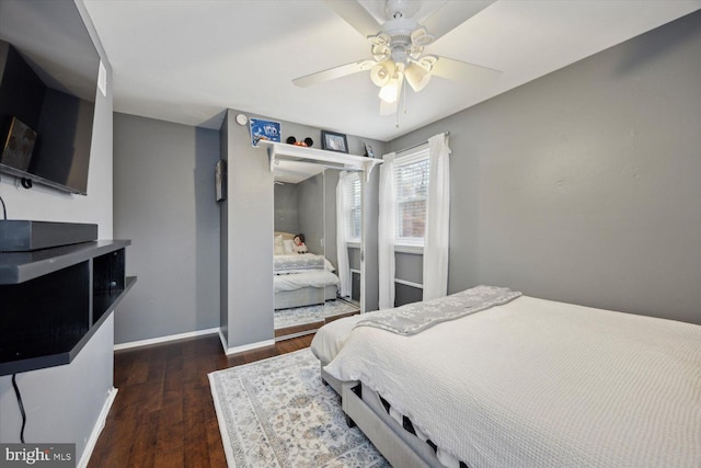 bedroom with dark hardwood / wood-style floors and ceiling fan