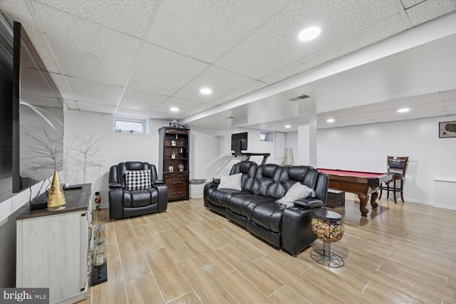 living room with light wood-type flooring, a paneled ceiling, and billiards