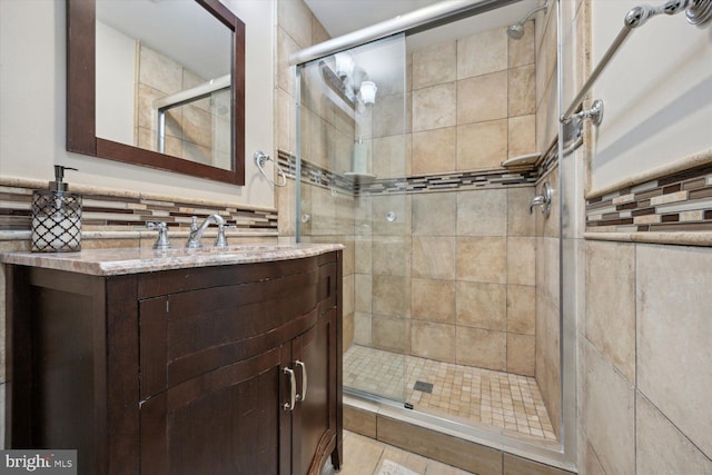 bathroom with tile patterned floors, vanity, and a shower with door