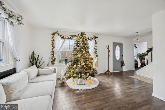 living room with a notable chandelier and dark hardwood / wood-style floors