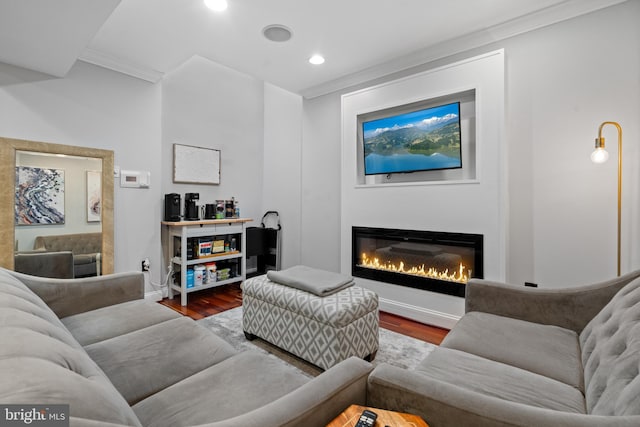 living room with ornamental molding and hardwood / wood-style flooring