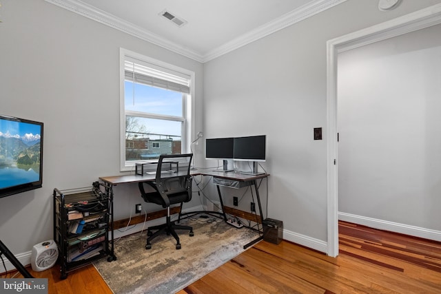 office area with hardwood / wood-style floors and crown molding