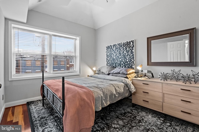 bedroom featuring lofted ceiling and dark wood-type flooring