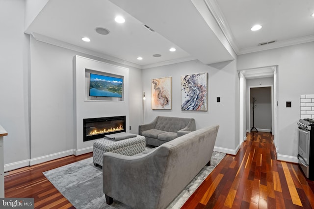 living room with dark hardwood / wood-style floors and crown molding