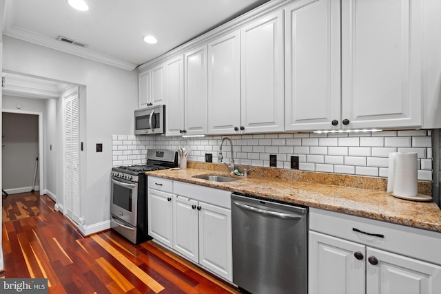 kitchen featuring crown molding, sink, white cabinets, and appliances with stainless steel finishes