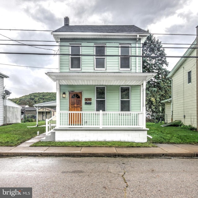 view of front of home featuring a front lawn and covered porch