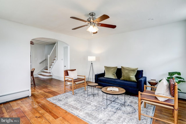 living room with hardwood / wood-style floors, ceiling fan, and a baseboard radiator