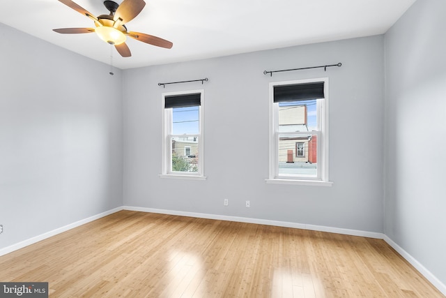 spare room featuring ceiling fan, plenty of natural light, and light hardwood / wood-style flooring