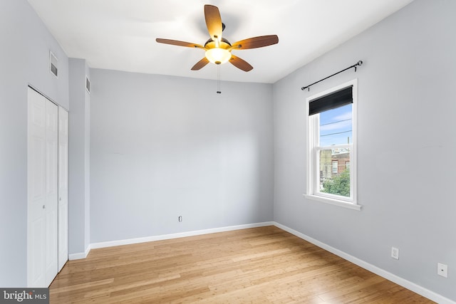 unfurnished bedroom with ceiling fan, a closet, and light wood-type flooring