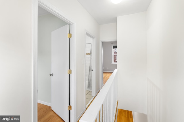 hallway with light hardwood / wood-style flooring