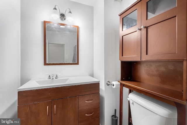 bathroom featuring vanity and toilet