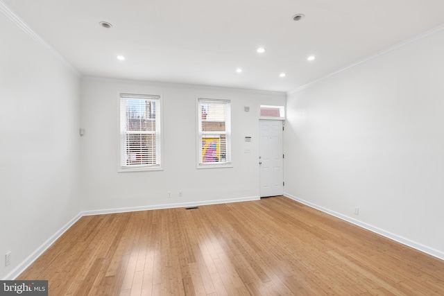 unfurnished room featuring crown molding and light hardwood / wood-style flooring